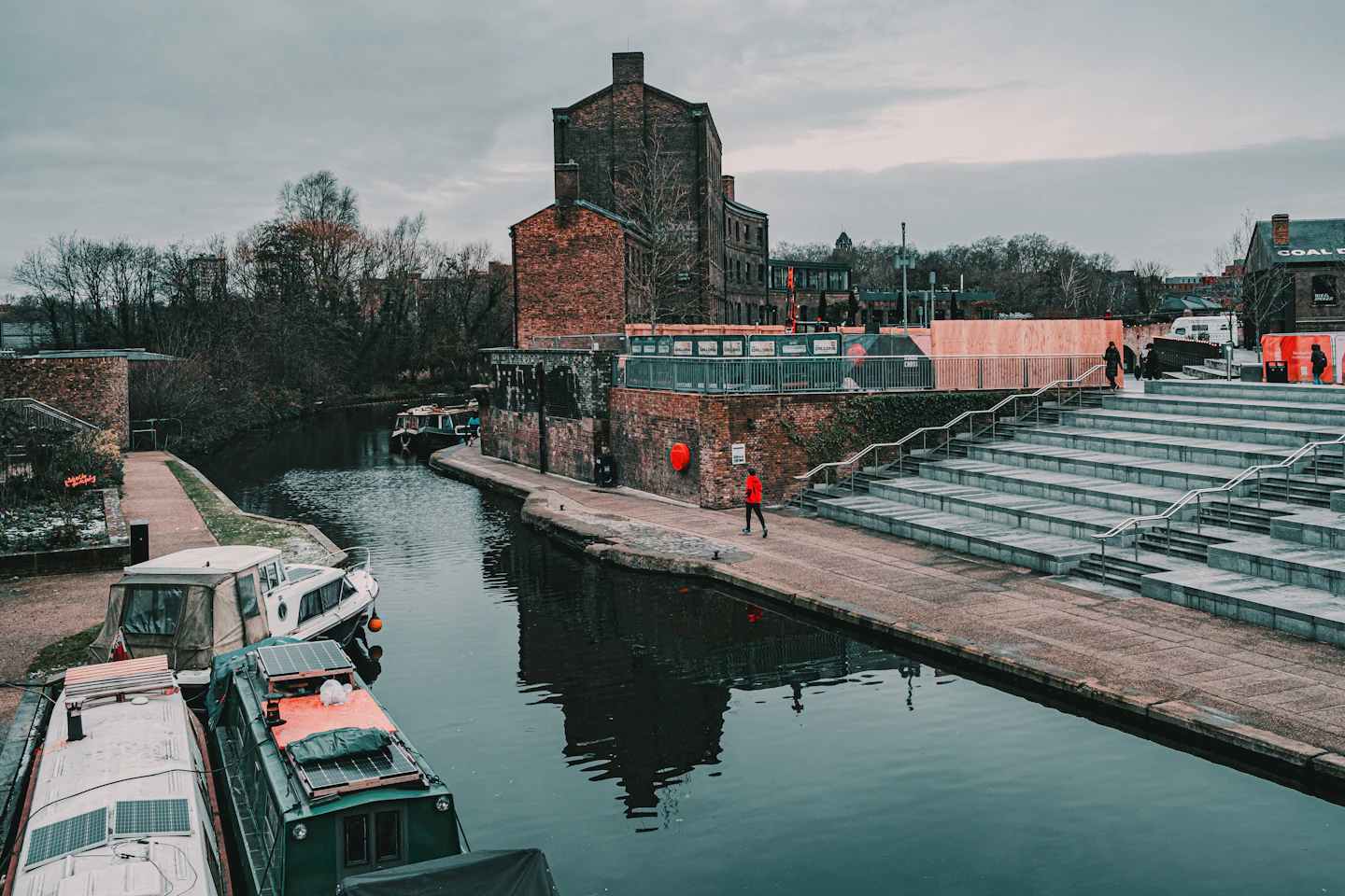 Historic brick buildings, canal and public steps at King's Cross, London